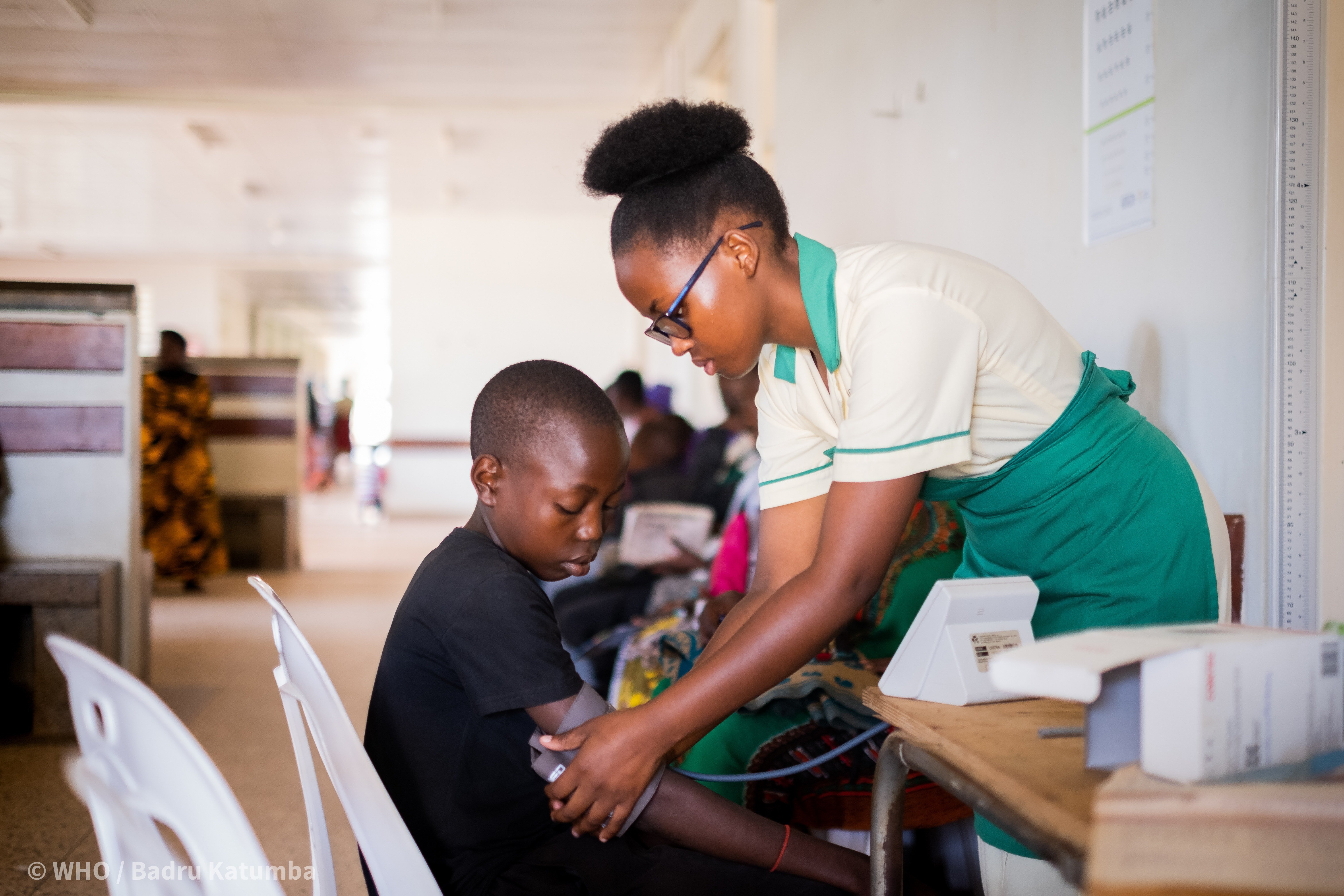 A nurse measures a child's blood pressure in Uganda